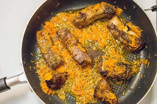 Fry ribs with carrots for couple minutes. Mix them with spatula.