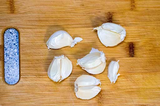 Clean top layers of garlic cloves